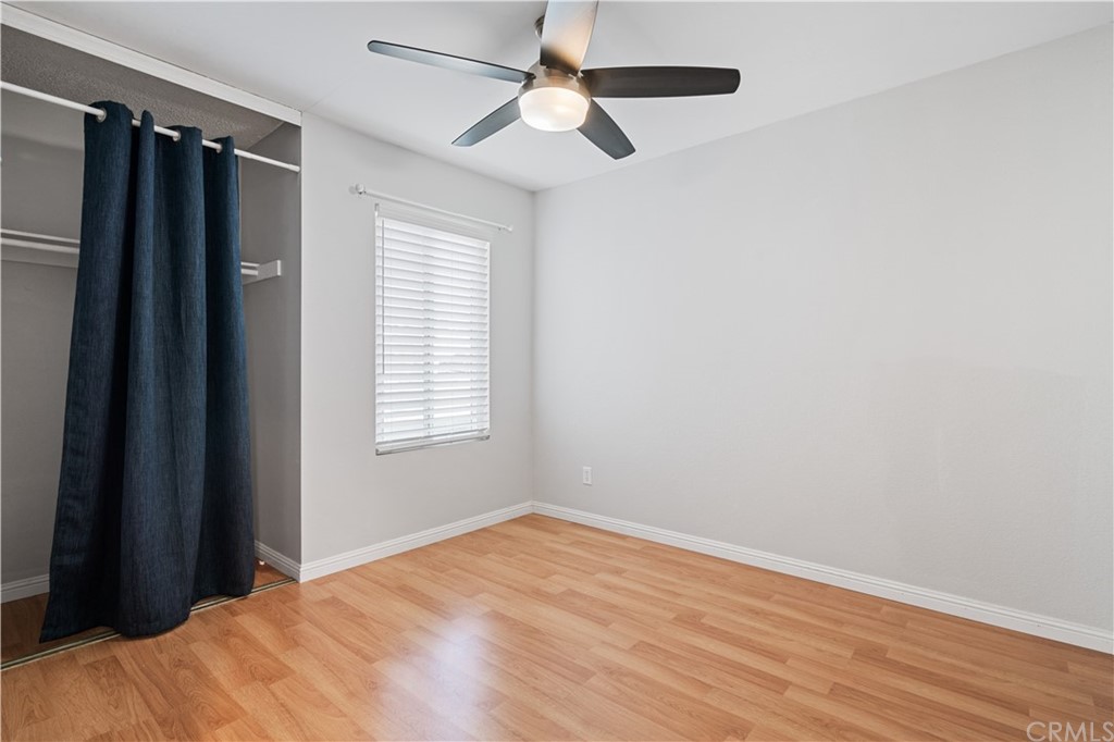 4435 Springtime Drive Oceanside, CA 92056 - Photo 18 of 52 a view of a room with a ceiling fan and wooden floor
