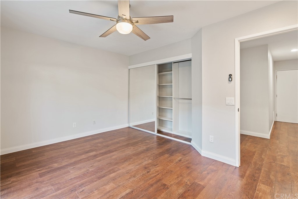 4435 Springtime Drive Oceanside, CA 92056 - Photo 22 of 52 an empty room with wooden floor closet ceiling fan and window