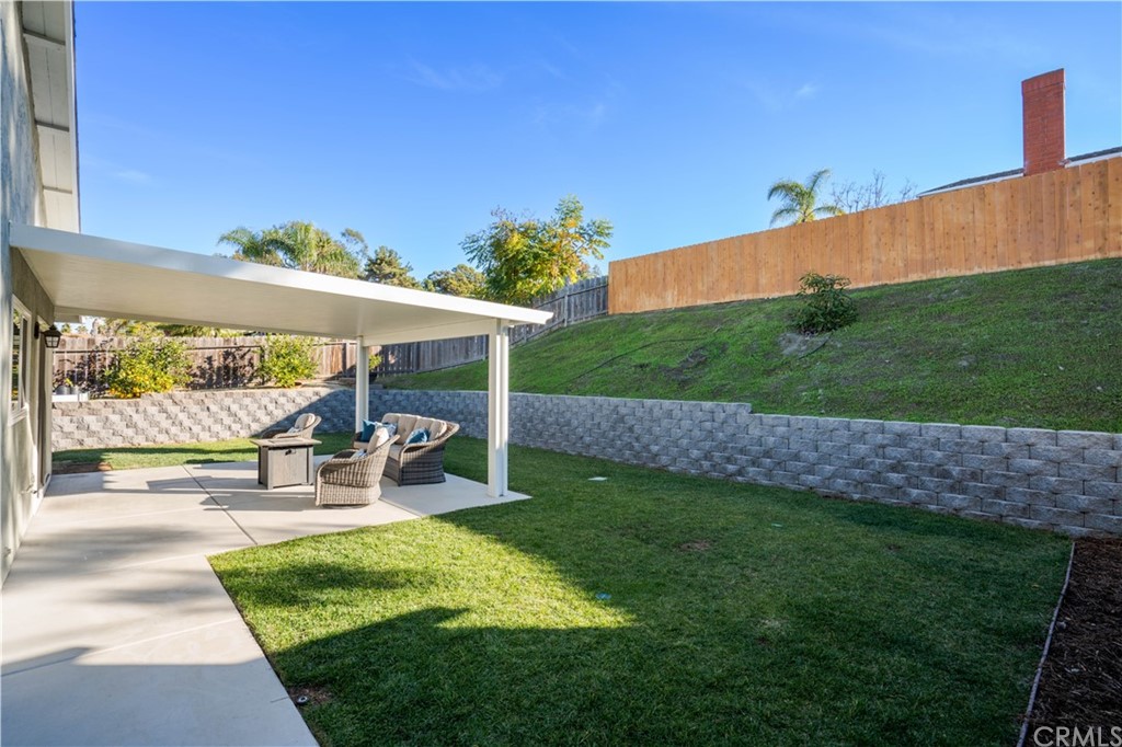 4435 Springtime Drive Oceanside, CA 92056 - Photo 29 of 52 a view of a patio with table and chairs under an umbrella
