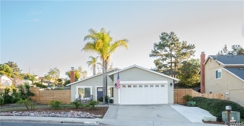 4435 Springtime Drive Oceanside, CA 92056 - Photo 45 of 52 a front view of a house with a yard and garage