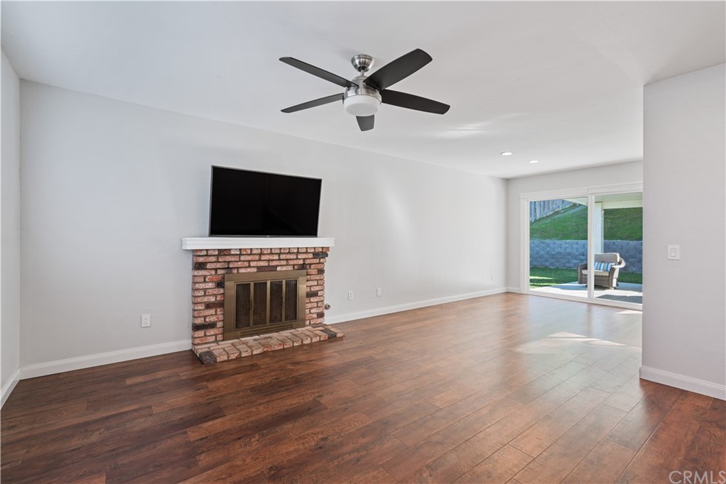4435 Springtime Drive Oceanside, CA 92056 - Photo 51 of 52 an empty room with fireplace wooden floor and windows