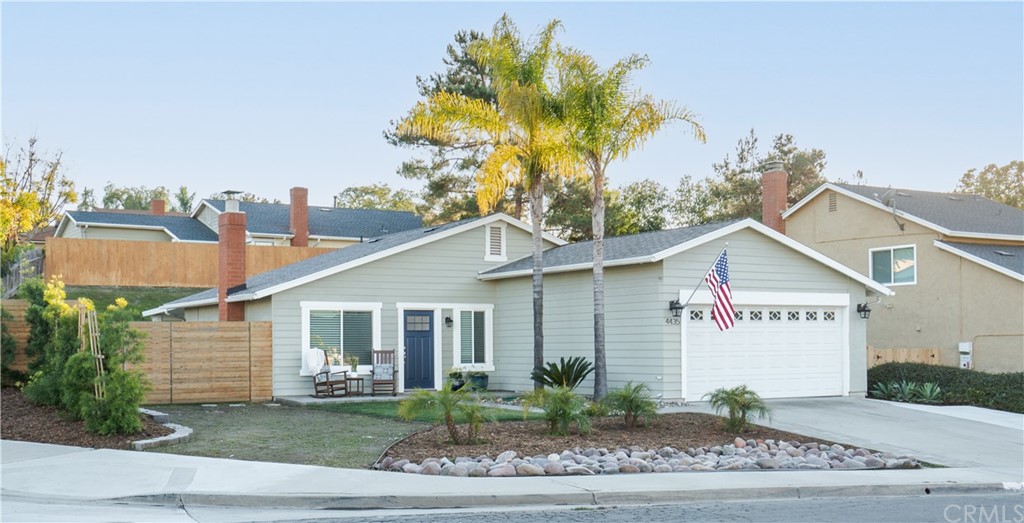4435 Springtime Drive Oceanside, CA 92056 - Photo 49 of 52 a view of a white house next to a yard and potted plants