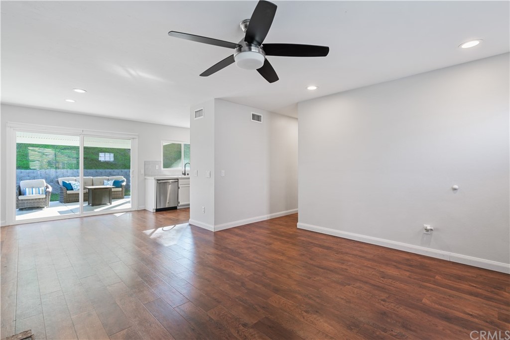 4435 Springtime Drive Oceanside, CA 92056 - Photo 6 of 52 a view of an empty room with wooden floor and a window