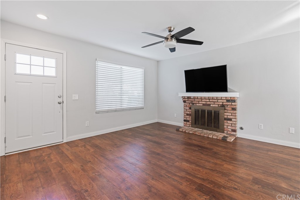4435 Springtime Drive Oceanside, CA 92056 - Photo 7 of 52 a view of an empty room with a fireplace and a window