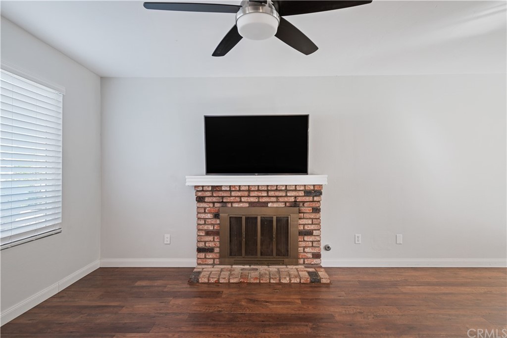4435 Springtime Drive Oceanside, CA 92056 - Photo 9 of 52 a living room with a fireplace and a window