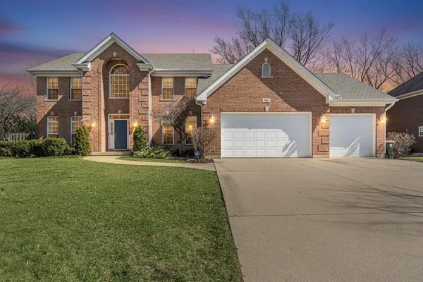 a front view of a house with a yard and garage