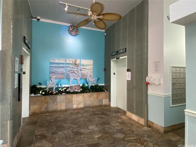 a front view of a building with streets and trees