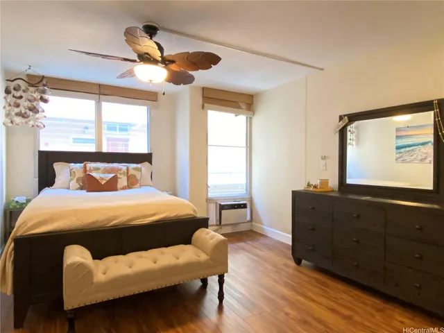 a spacious bedroom with a bed and a mirror