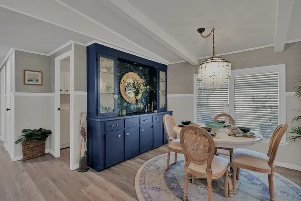 a dining room with furniture and wooden floor