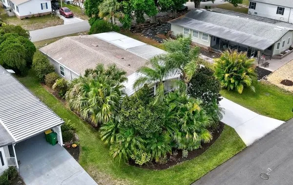 an aerial view of a house with garden space and street view