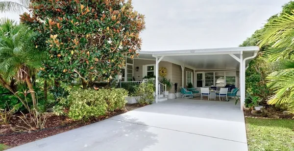 a view of a house with sitting area and garden