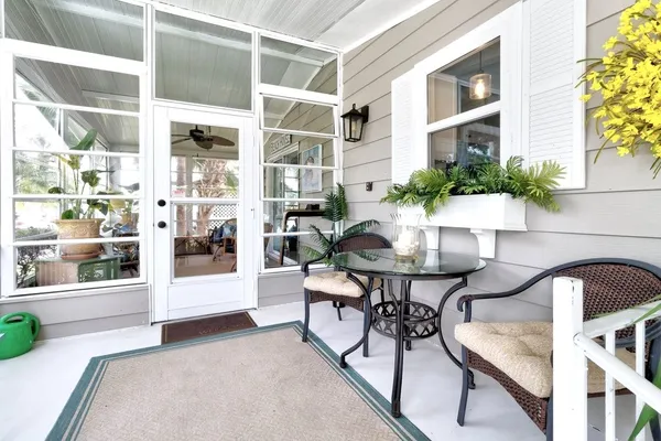 a view of a patio with table and chairs and potted plants