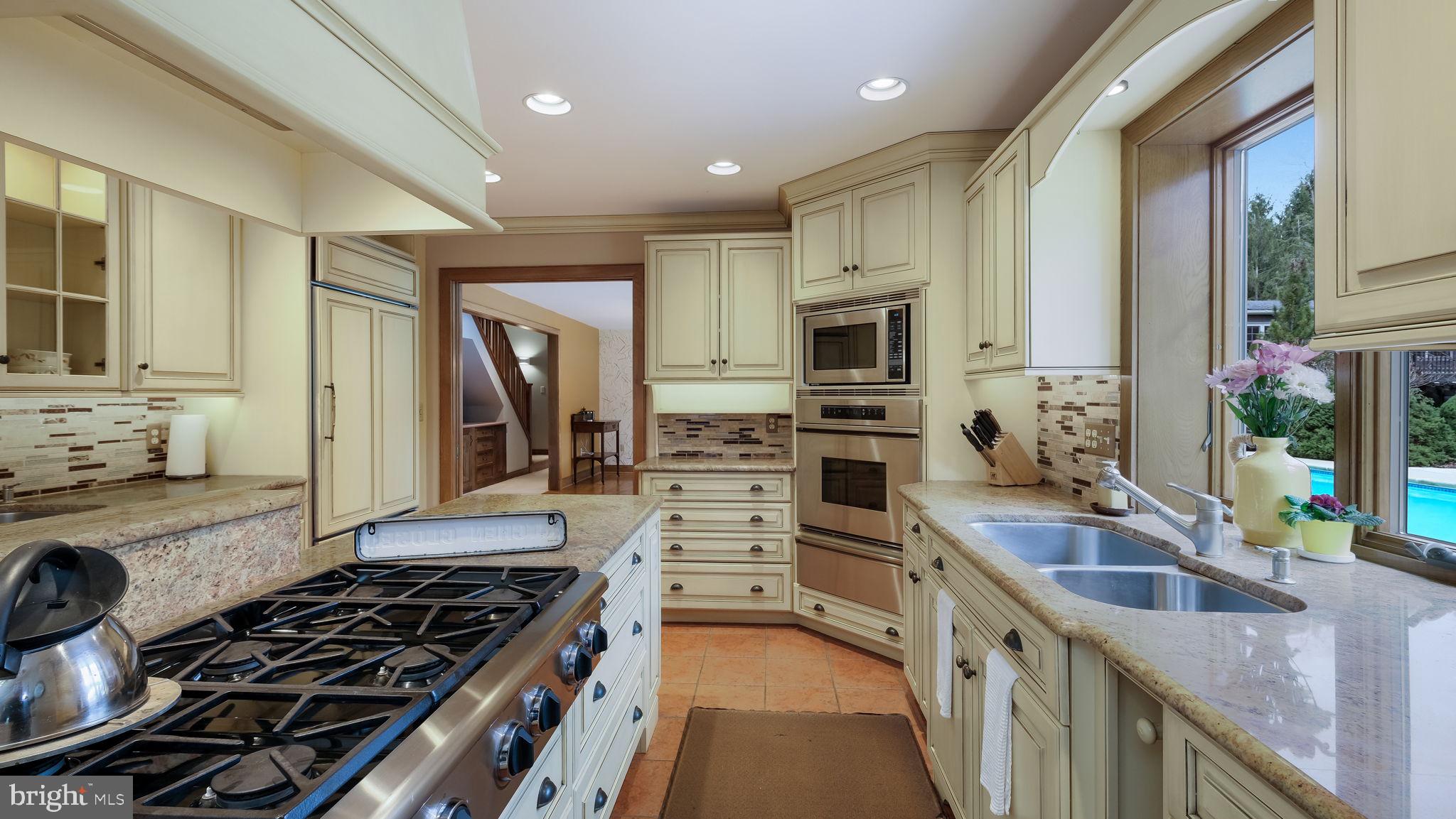 46 Valley Road New Hope, PA 18938 - Photo 15 of 56 a kitchen with kitchen island granite countertop a sink stove and cabinets