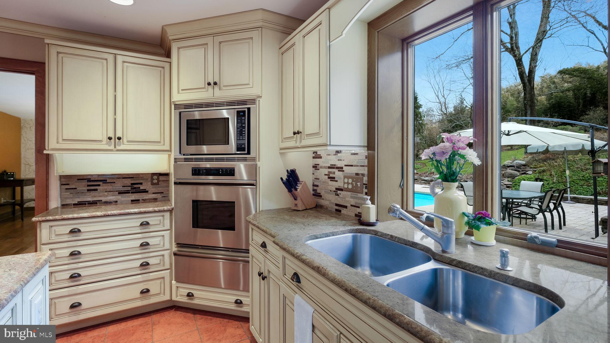 46 Valley Road New Hope, PA 18938 - Photo 16 of 56 a kitchen with stainless steel appliances granite countertop a sink stove and cabinets