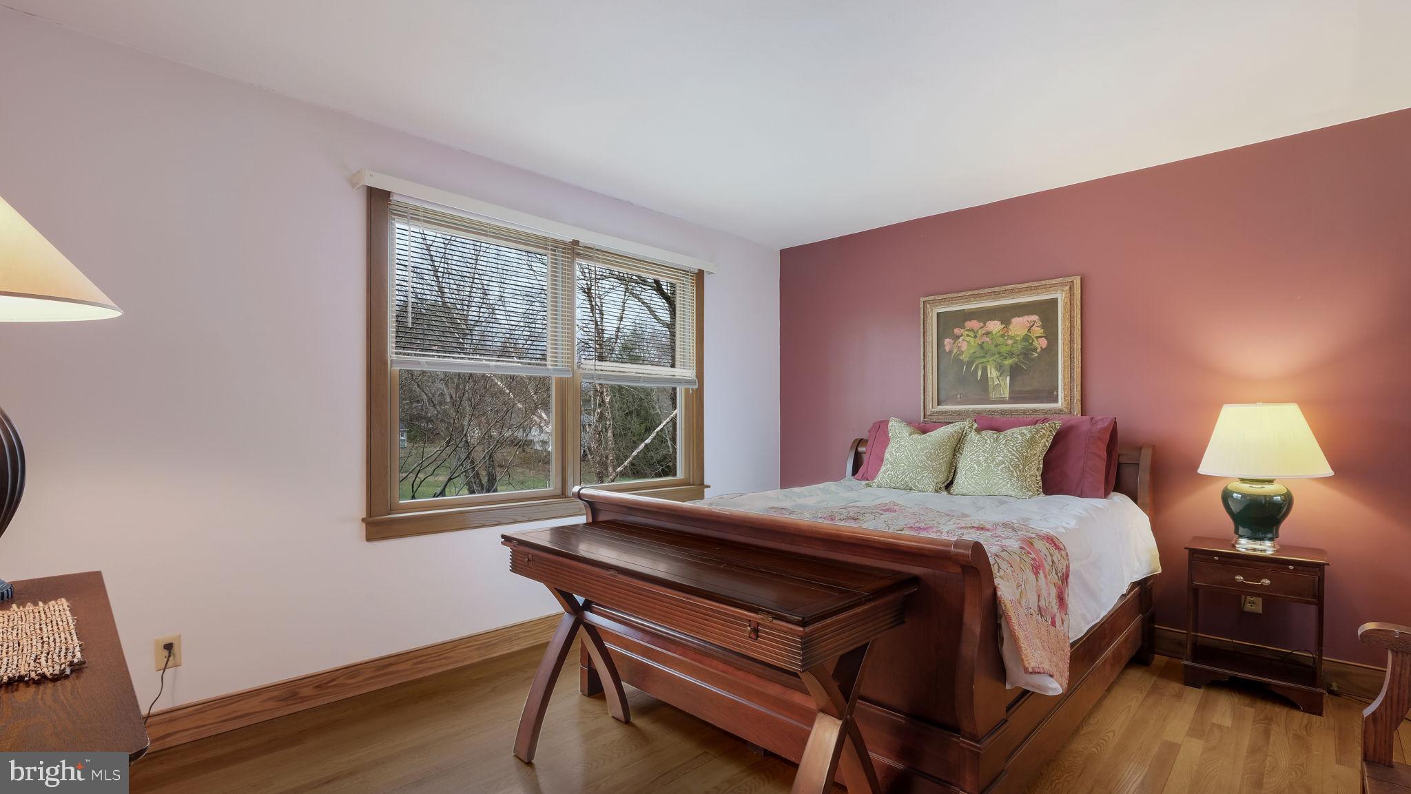 46 Valley Road New Hope, PA 18938 - Photo 18 of 56 a bedroom with a bed a lamp and a window
