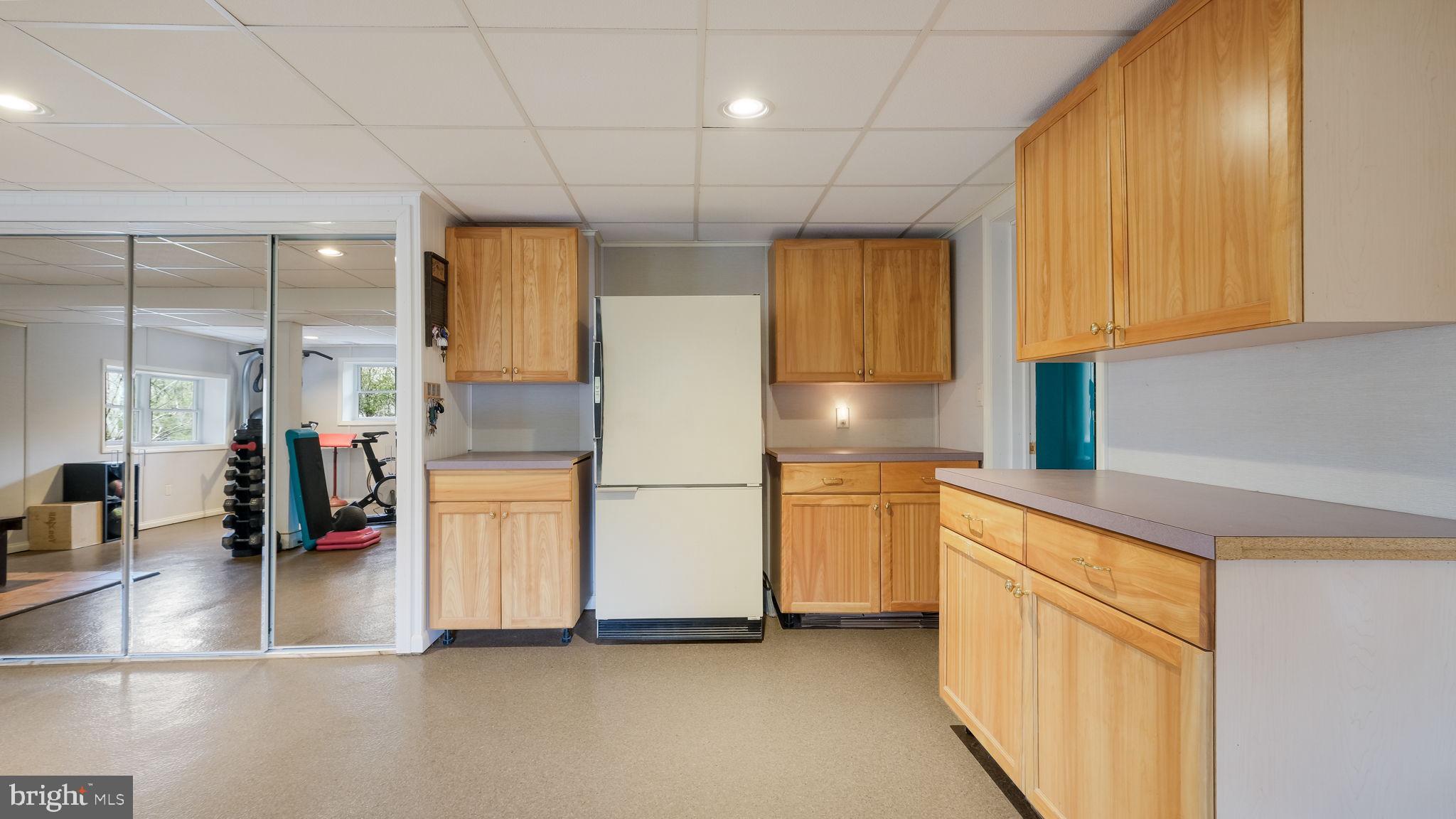 46 Valley Road New Hope, PA 18938 - Photo 33 of 56 a kitchen with stainless steel appliances granite countertop a refrigerator a stove and a sink with wooden floor