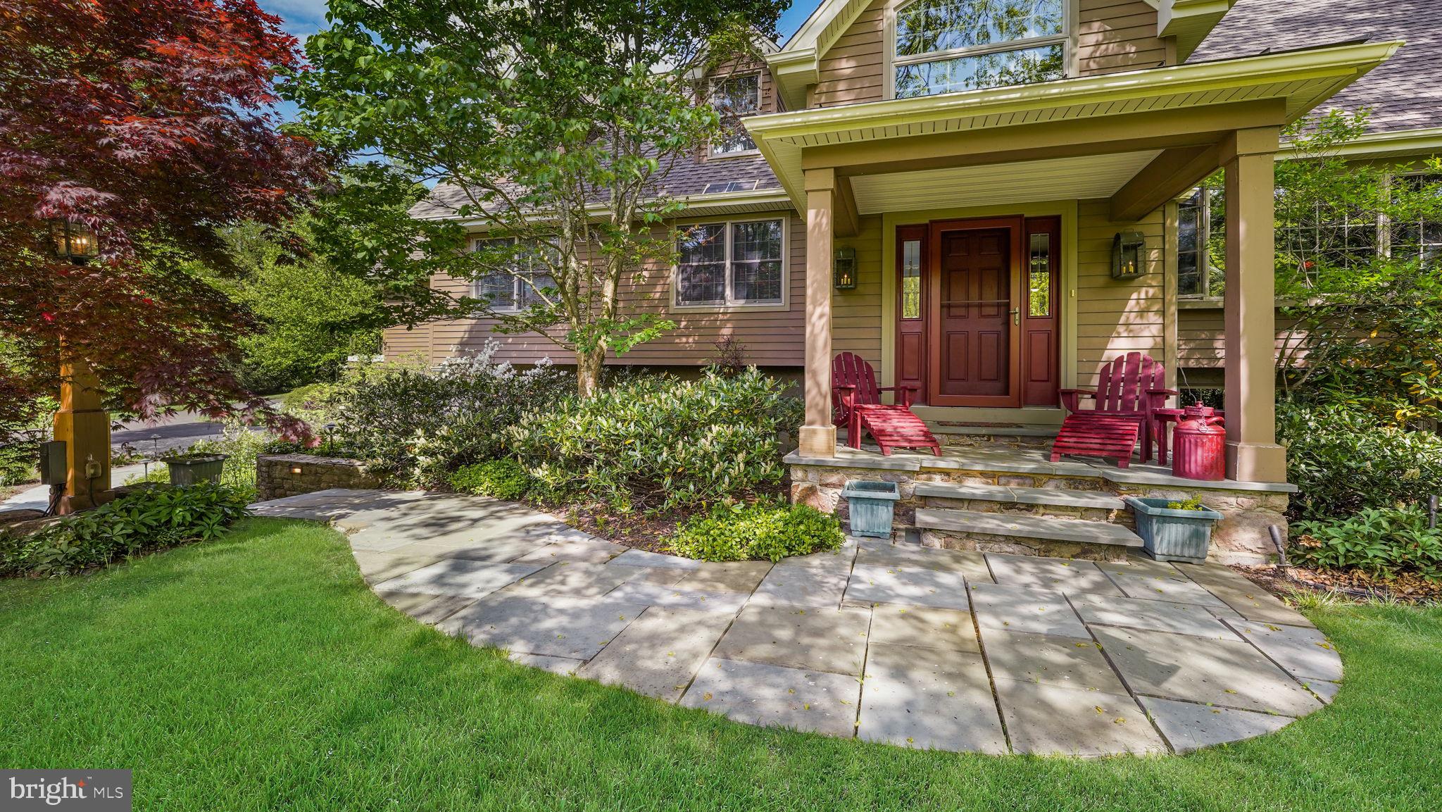 46 Valley Road New Hope, PA 18938 - Photo 7 of 56 a view of a house with potted plants and a bench