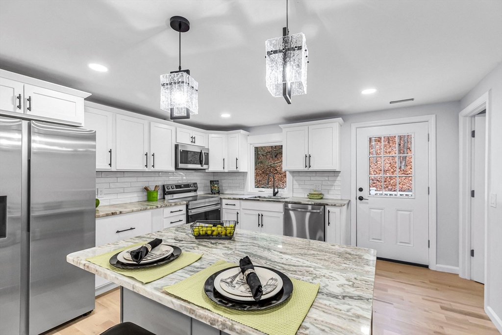 143 James Street Ludlow, MA 01056 - Photo 11 of 41 a kitchen with refrigerator and wooden floor