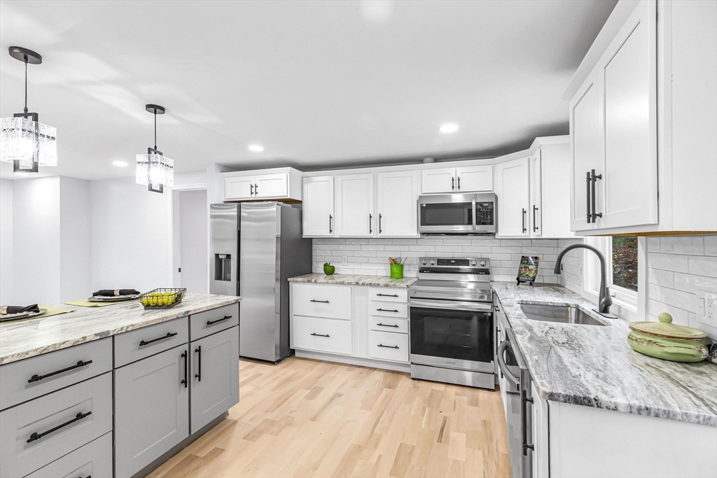 143 James Street Ludlow, MA 01056 - Photo 14 of 41 a kitchen with granite countertop a sink stainless steel appliances and cabinets