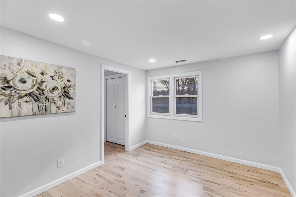 143 James Street Ludlow, MA 01056 - Photo 16 of 41 a view of an empty room with window and wooden floor