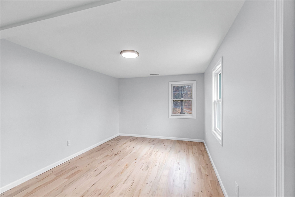 143 James Street Ludlow, MA 01056 - Photo 17 of 41 an empty room with wooden floor and windows