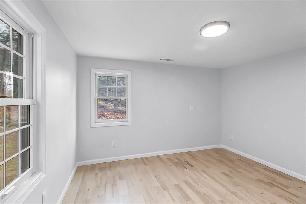 143 James Street Ludlow, MA 01056 - Photo 19 of 41 an empty room with wooden floor and windows