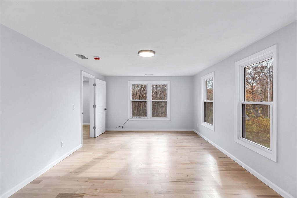 143 James Street Ludlow, MA 01056 - Photo 25 of 41 a view of an empty room with a window and wooden floor