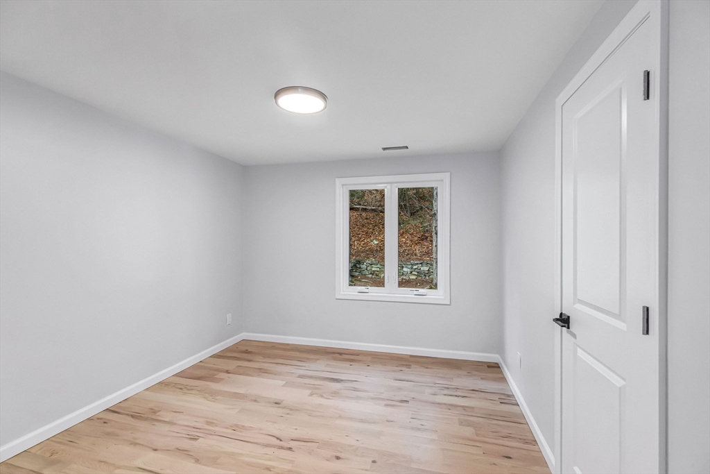 143 James Street Ludlow, MA 01056 - Photo 26 of 41 an empty room with wooden floor and windows