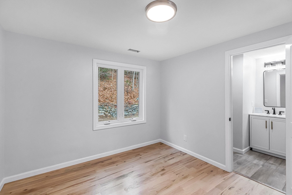 143 James Street Ludlow, MA 01056 - Photo 27 of 41 an empty room with wooden floor cabinet and windows