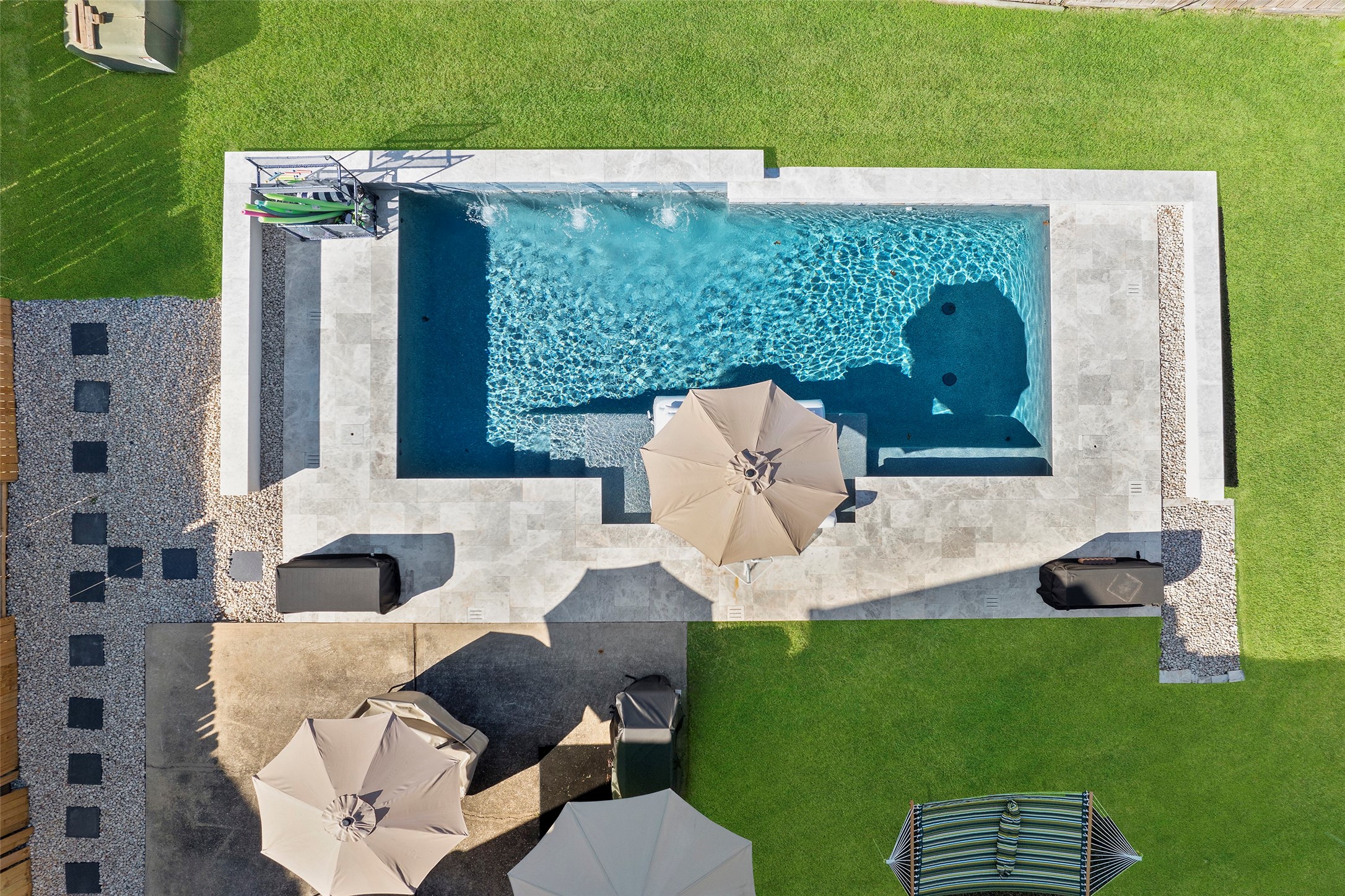 Aerial view showcasing the resort style backyard and stunning pool.
