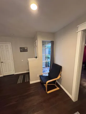 a living room with a chair and a window