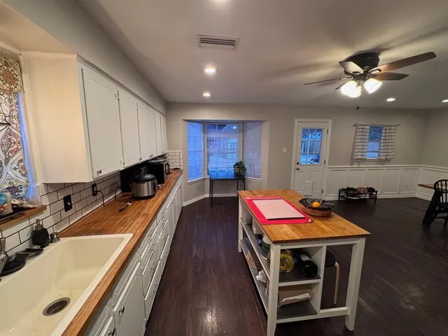 a room with furniture pool table and wooden floor