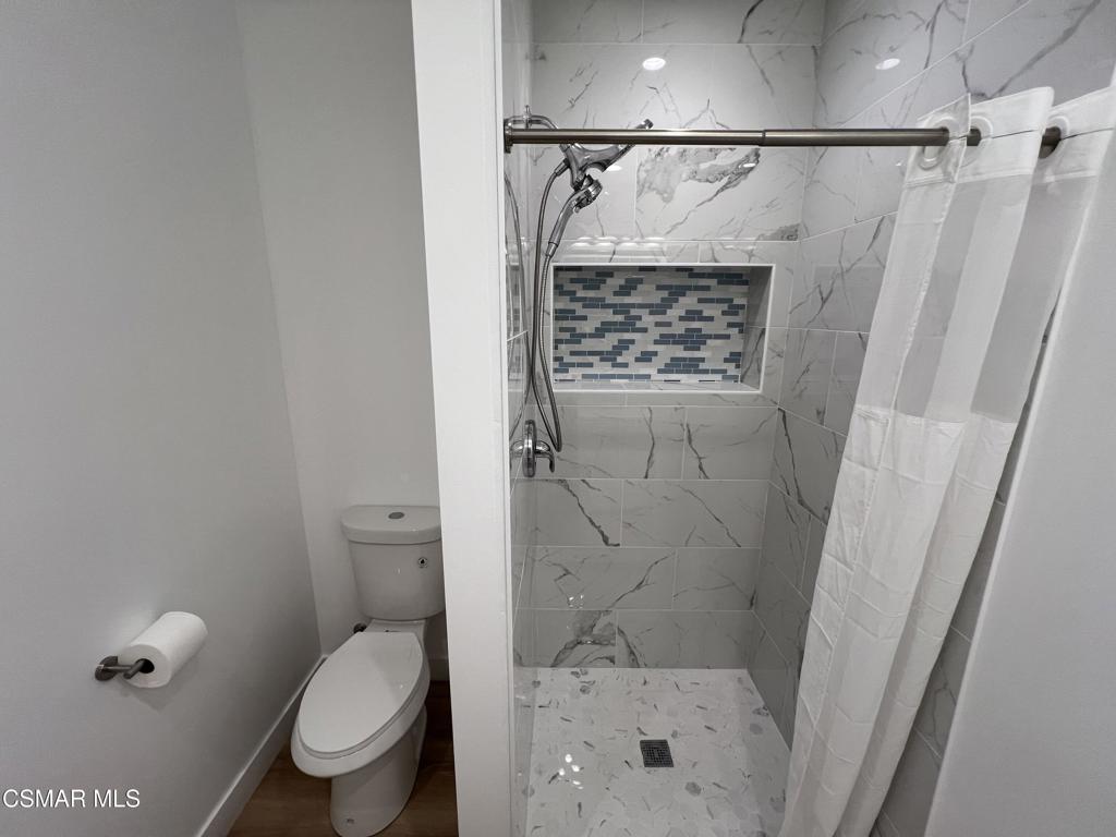 1666 1/2 Stoddard Avenue Thousand Oaks, CA 91360 - Photo 12 of 17 a bathroom with a shower toilet and sink