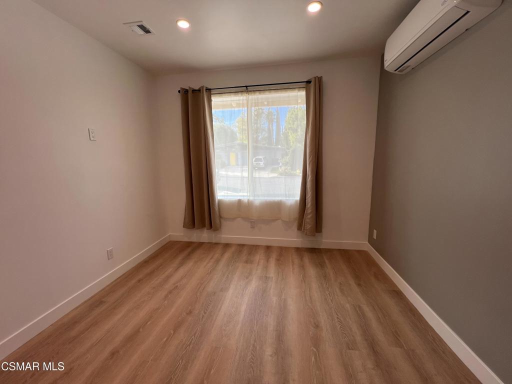 1666 1/2 Stoddard Avenue Thousand Oaks, CA 91360 - Photo 13 of 17 an empty room with wooden floor and windows