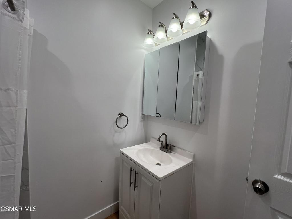 1666 1/2 Stoddard Avenue Thousand Oaks, CA 91360 - Photo 6 of 17 a bathroom with a sink and mirror