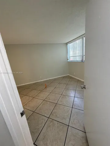 a kitchen with a sink a refrigerator and cabinets