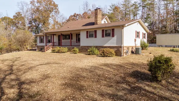 a front view of a house with a yard covered in snow