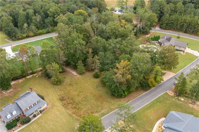 a view of a yard with wooden fence