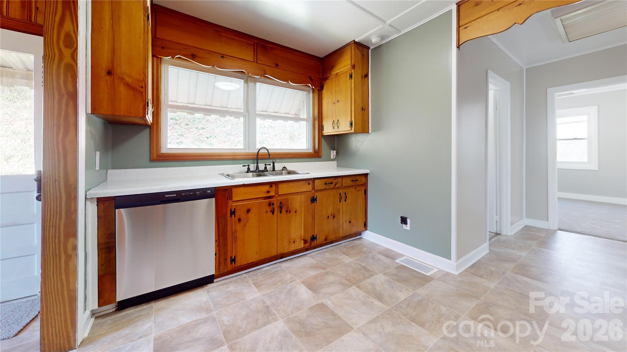 882 Poison Cove Road Clyde, NC 28721 - Photo 12 of 22 a kitchen with a stove a sink and a window