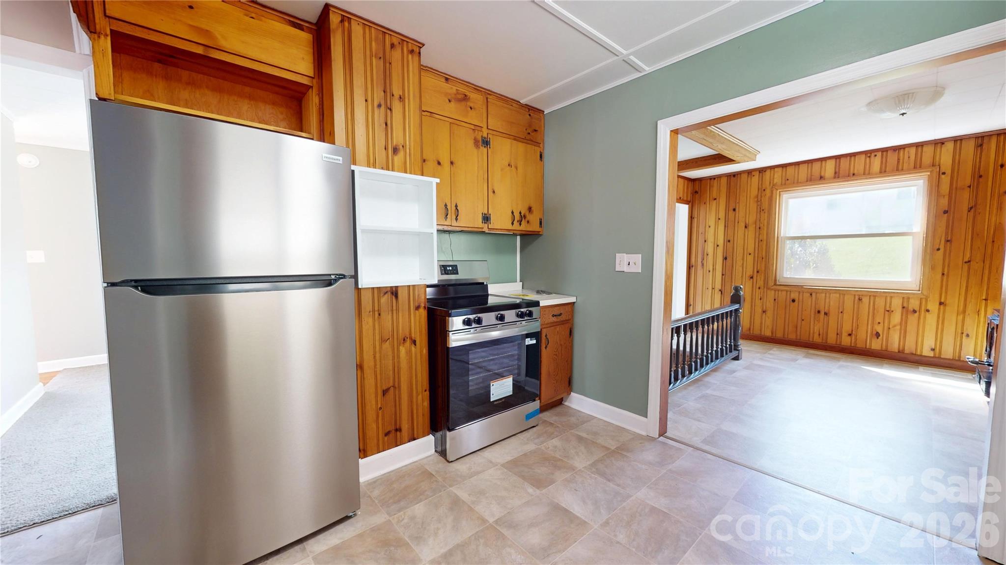 882 Poison Cove Road Clyde, NC 28721 - Photo 14 of 22 a kitchen with refrigerator and cabinets