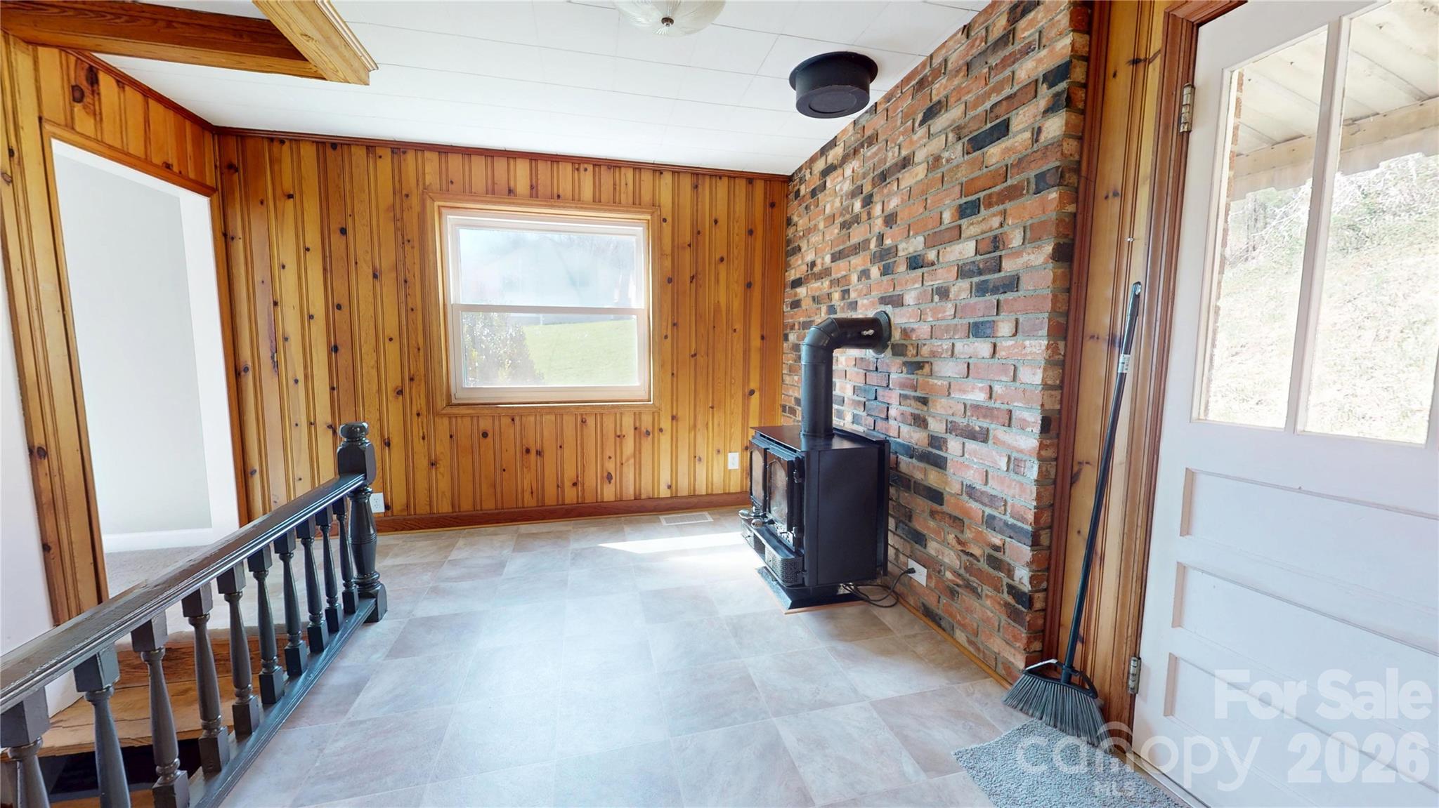 882 Poison Cove Road Clyde, NC 28721 - Photo 15 of 22 a view of an empty room with a fireplace and a window