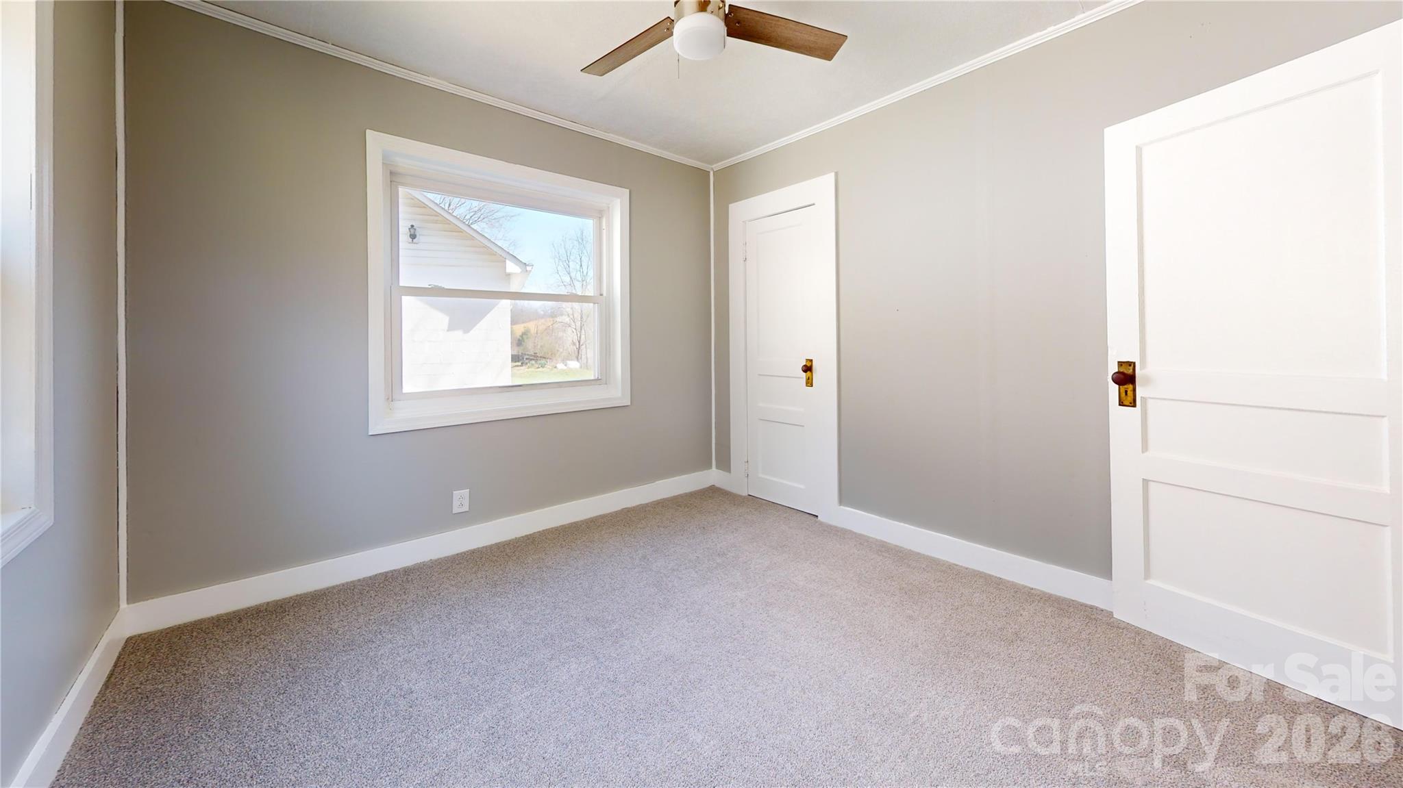 882 Poison Cove Road Clyde, NC 28721 - Photo 19 of 22 a view of an empty room with a window