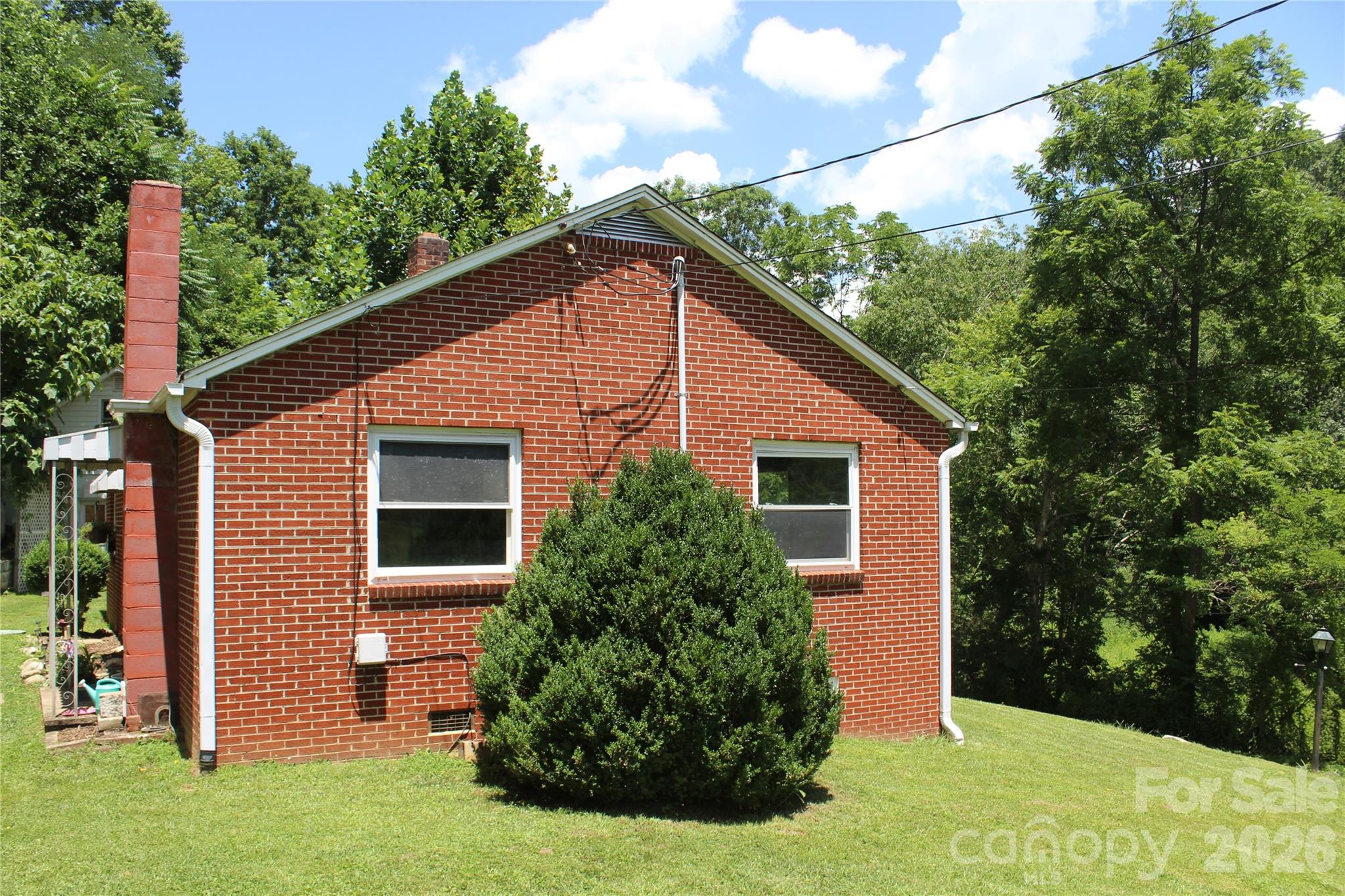 882 Poison Cove Road Clyde, NC 28721 - Photo 3 of 22 a view of a house with backyard and garden