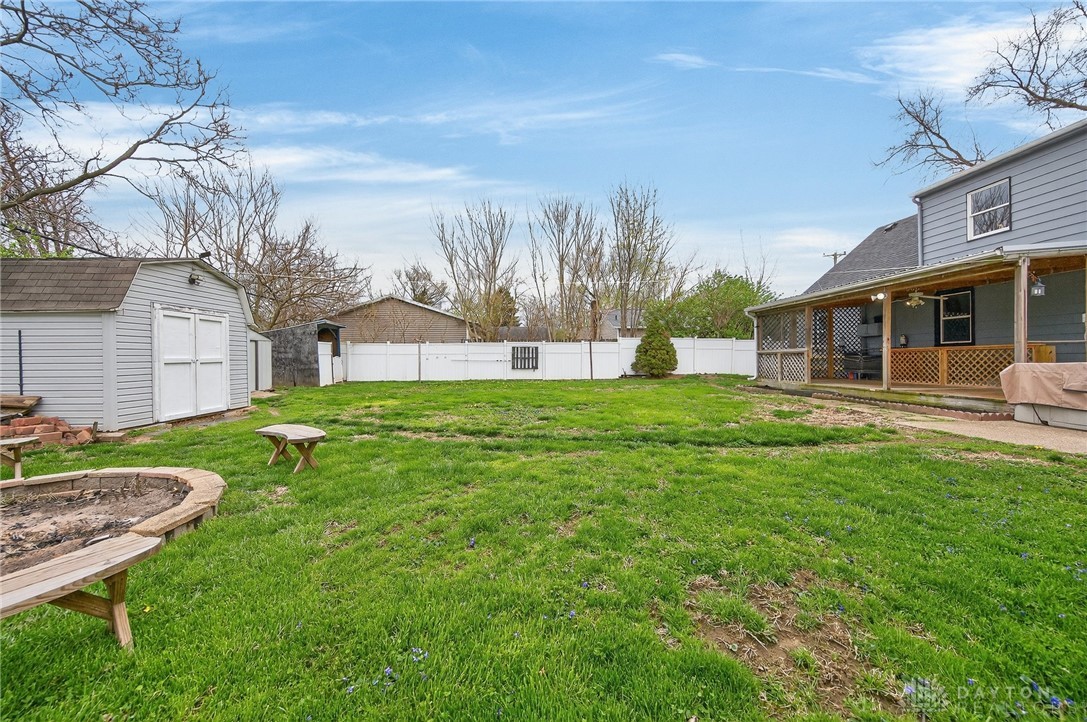 3301 Wildwood Road Middletown, OH 45042 - Photo 54 of 68 The expansive backyard features a detached shed, a comfortable patio, and a fire pit, perfect for outdoor enjoyment.