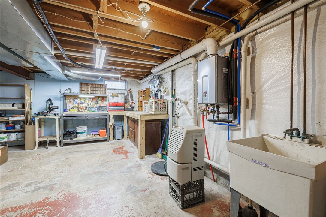 362 Webster Road Webster, NY 14580 - Photo 34 of 46 Workbench and tankless hot water heater