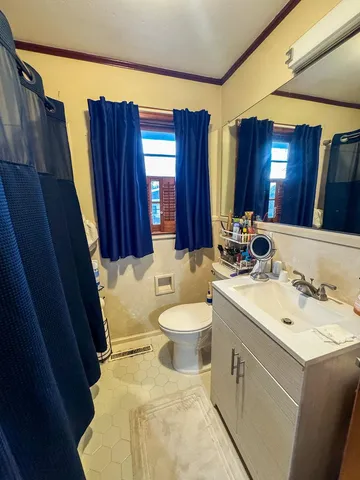 a bathroom with a sink a toilet and mirror