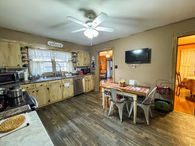 a kitchen with a table chairs sink and cabinets