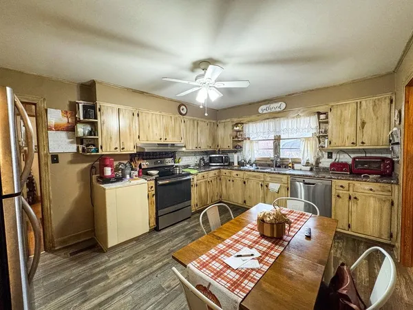a kitchen with sink refrigerator and window