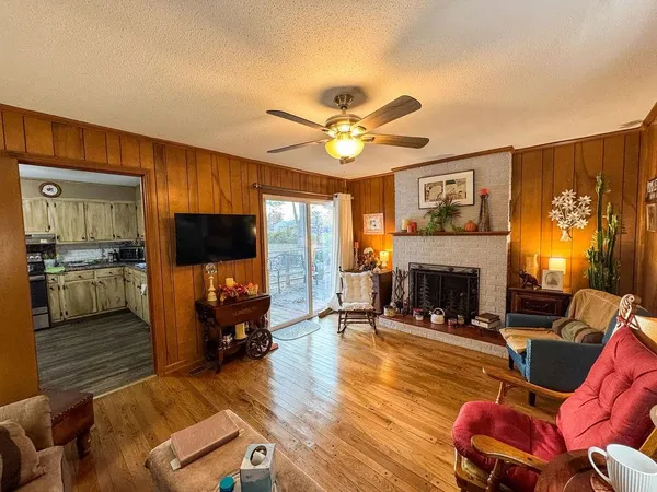 a living room with furniture fireplace and flat screen tv