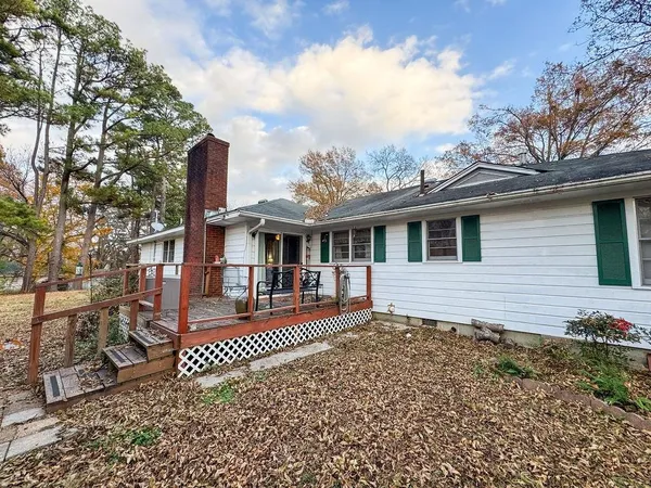 a front view of a house with yard tree and wooden fence